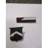 Two Suffragette enamel badges, 'Votes for Women W.S.P.U.' shield shape, and 'Fellowship Votes for