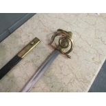 A Danish brass hilted sword in leather scabbard, bears BGC stamp for 'Den Bestandige