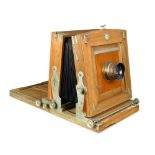 An early 20th century plate camera, the mahogany case bearing the label 'Neue Gorlitzer Camera-