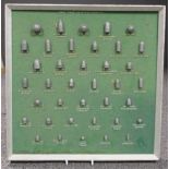 A collection of re-cast shots and bullets, mounted on a display board, 42cm square