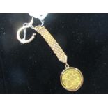 A gold sovereign, dated 1925, mounted on a keyring