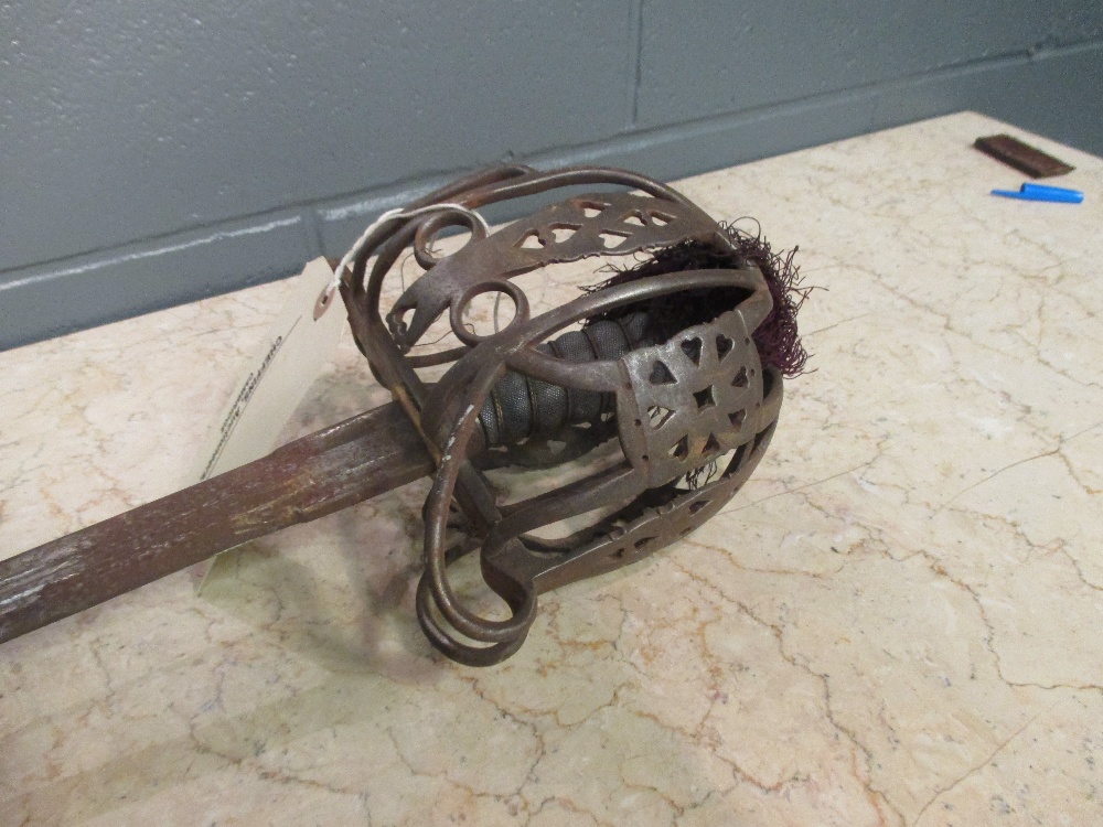 A Victorian Scottish basket hilt sword, standard pattern, the rusted etched blade and with proof