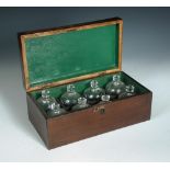 A 19th century boxwood and satinwood strung mahogany fitted box, containing a set of eight cupping