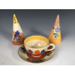 A Clarice Cliff Crocus pattern conical sifter, together with a Crocus pattern cup and saucer and