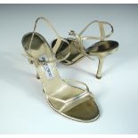 Jimmy Choo, a pair of pale gold leather stiletto evening sandals, buckle ankle strap with 10cm