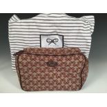 Anya Hindmarch, a washbag, water resistant exterior decorated with Anya Hindmarch logo, emblem and