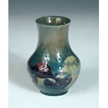 A Moorcroft Claremont pattern vase, the small baluster form decorated to a green ground, painted and