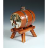 A Royal Doulton Dickens Ware spirit barrel on stand with silver mounts and spigot, decorated to