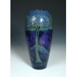 A Moorcroft Moonlit Blue pattern vase, the ovoid form decorated to a deep blue ground, painted and