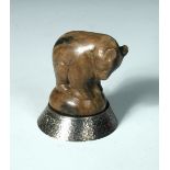 A carved soapstone model of a bear, modelled standing and mounted upon a white metal base, baring