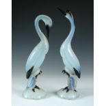 A pair of mid-20th century Murano glass cranes, the opalescent and black glass models each