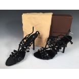 Louis Vuitton, a pair of black stiletto evening open toe sling backs, with strapwork upper decorated