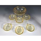 An Art Deco yellow glass fruit salad set, comprising six small bowls and a serving bowl, each of