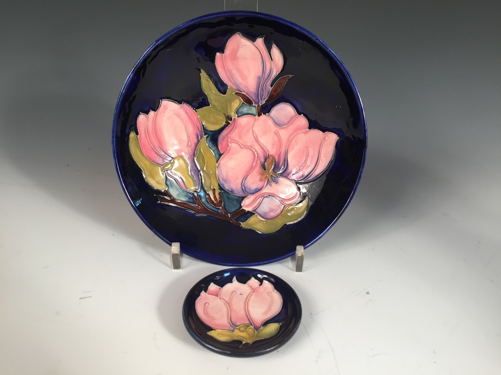 A Moorcroft Magnolia pattern bowl, decorated to a deep blue ground, painted and impressed marks,