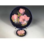 A Moorcroft Magnolia pattern bowl, decorated to a deep blue ground, painted and impressed marks,