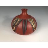 A Poole Pottery red stoneware vase by Catherine Connett, circa 1975, the thrown vessel with carved