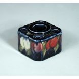 A Moorcroft Wisteria pattern inkwell, the square form with canted corners, the top with central well