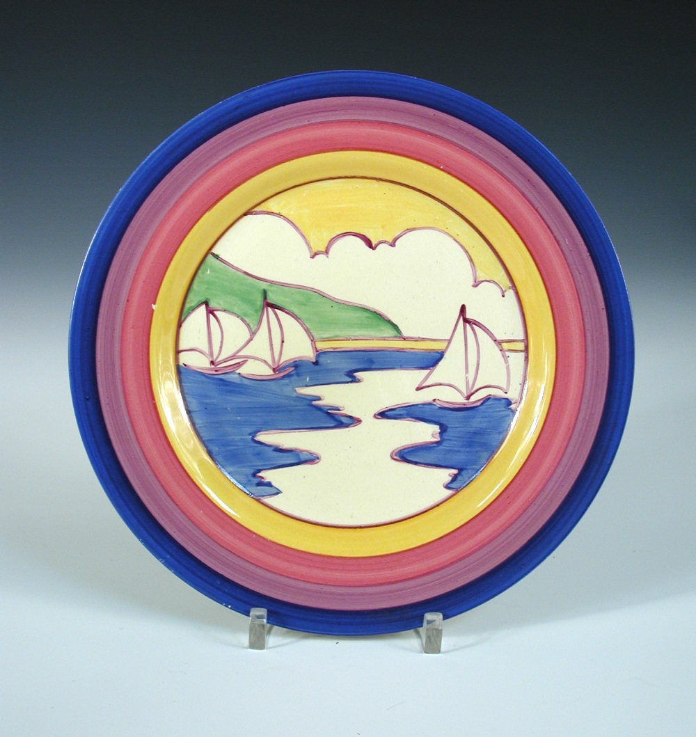 A Clarice Cliff Gibralter pattern plate, with banded border in blue, pinks and yelloiw, printed