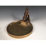 After Michael Powolny, a bronze dish mounted with a putti riding a bear, signed in the bronze 18 x