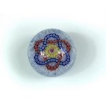 A modern Baccarat glass paperweight, with interlaced trefoil garlands on a filigree ground, etched