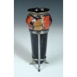 A Moorcroft Pomegranate pattern urn form vase within an electroplate stand, decorated to a green