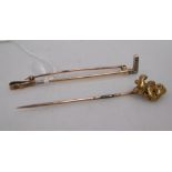 A diamond set riding crop stock pin and a 'gold nugget' stick pin (2)