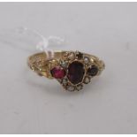 A posy style ring set with garnet and pearls, band stamped 9ct