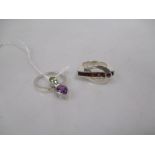 An unusual amethyst and peridot ring/pendant, the pear shaped amethyst and oval peridot that has