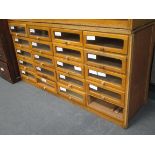 An oak Haberdashery cabinet with glass front drawers, 94 x 176 x 54cm