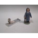 A Copenhagen porcelain figure of a mermaid together with a boy in a raincoat