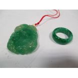 A Chinese jadeite pendant carved with gourds, cash and bats together with a ring (2)