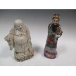 A Chinese porcelain deity wearing Imperial robes together with a white figure of Budai tallest