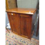 A Victorian rosewood medicine cabinet, two panelled doors enclosing open shelf and two small