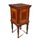 A Morris & Co. walnut pot cupboard, the square top with panelled sides, the door opening to reveal a