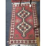 A 20th century red ground rug, 121 x 78cm