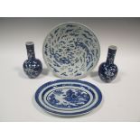 Two Chinese blue and white dishes together with a pair of bottle vases