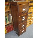 An oak upright filing cabinet, 130 x 43 x 69cm and a light oak desk, 77 x 152 x 84cm (2)