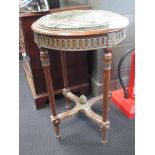 An Empire style green marble topped occasional table on four legs, the stretcher with metal