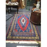 A Turkish blue ground rug with central medallion, 295cm x 159cm