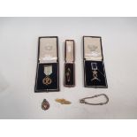 Two cased medals, two brooches, a silver fob and a bracelet