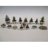 A group of continental porcelain miniature flower pots and plants tallest, 10cm high