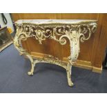 A Louis XV style console table, giltwood and painted carved and pierced with acanthus (lacking top),