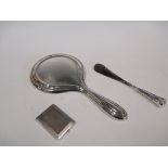 A silver backed hand mirror, a shoehorn and a matchbox sleeve