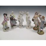 A pair of continental porcelain figures of musicians; a pair of bisque porcelain figurines of