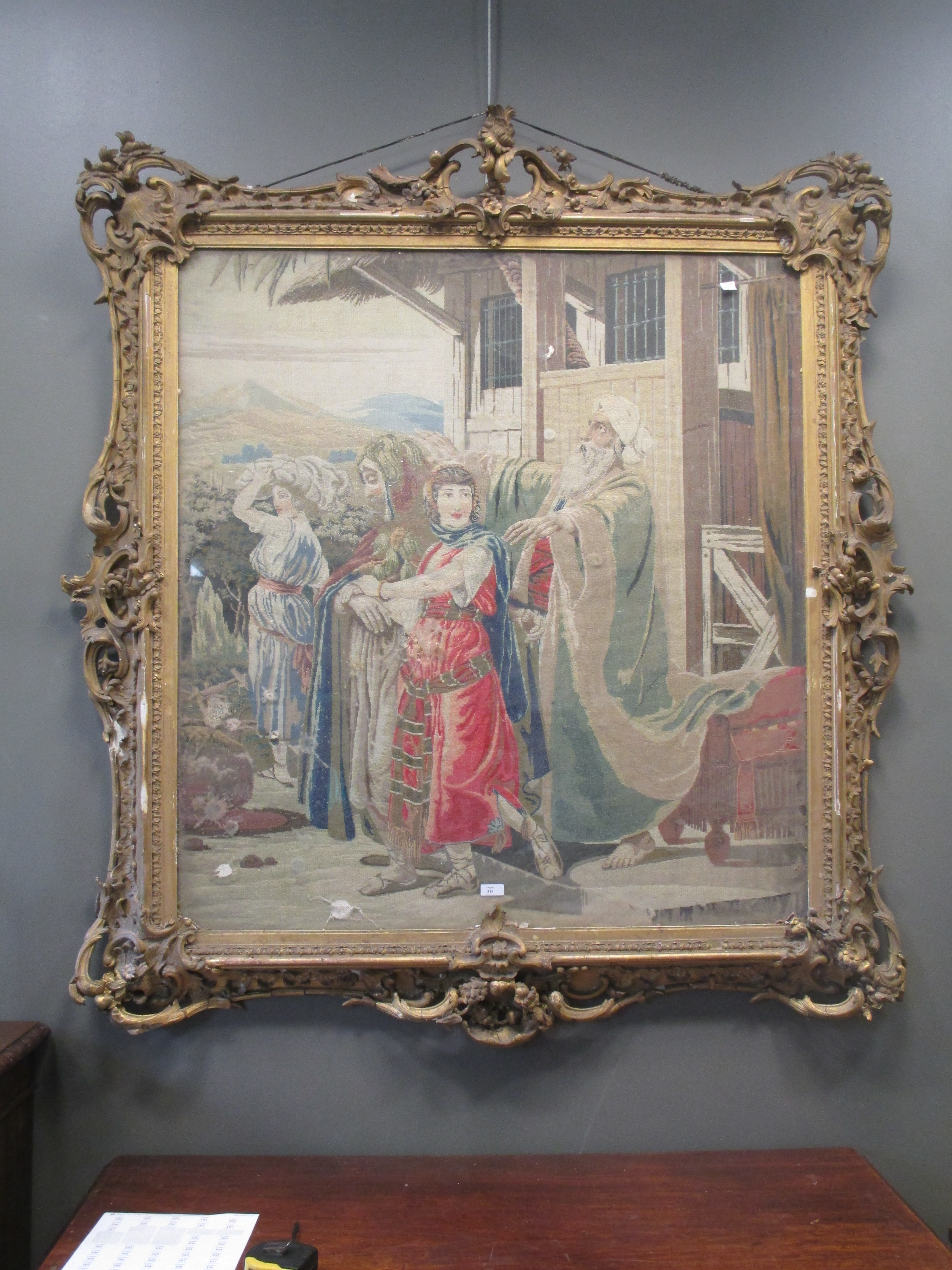 A large needlepoint of a Biblical scene in an ornate gilt frame, 143 x 133cm
