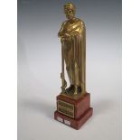 An early 20th century bronze figure of a man, signed H Miller on a stone base, 26cm