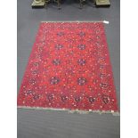 A 20th century plum and geometric ground rug, 207 x 151cm