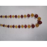 An amber, agate and mother of pearl bead necklace