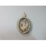 A pendant miniature portrait in pearl embellished frame, the oval watercolour portrait of a late