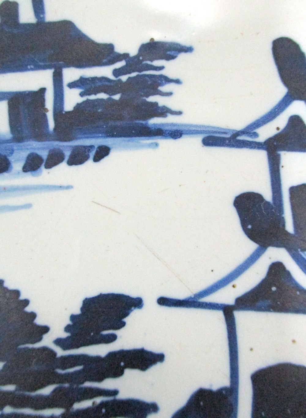 A small 18th century Delft blue and white charger, painted with a river landscape, 30cm diameter; - Image 26 of 49